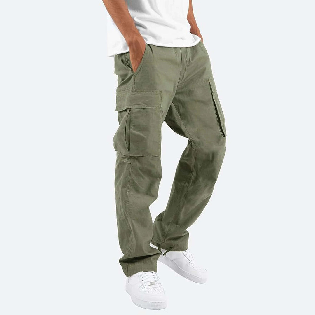 Groene cargobroek voor heren, Ryker model, met meerdere zakken, casual stijl, gecombineerd met witte sneakers en een wit T-shirt.
